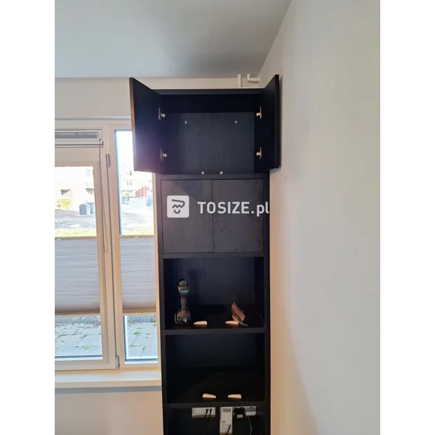 Black cupboard wall with doors and open compartments