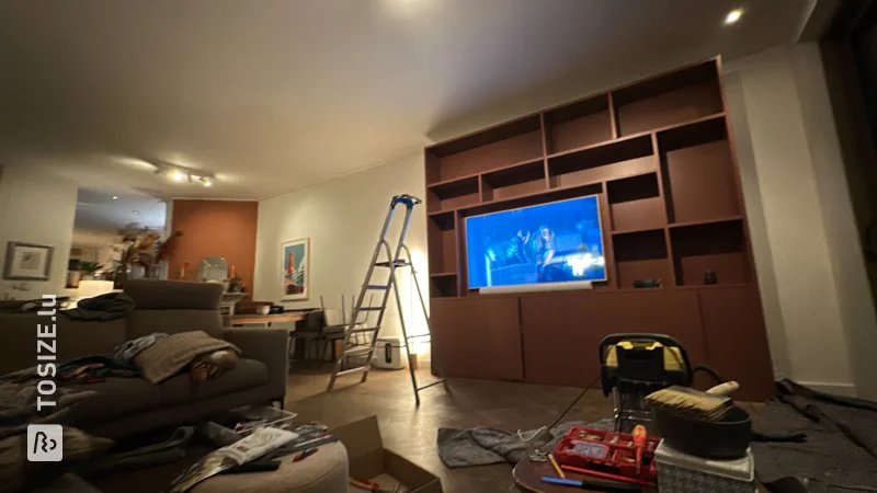 A stylish rust-colored TV and bookcase for the living room, by Bastiaan