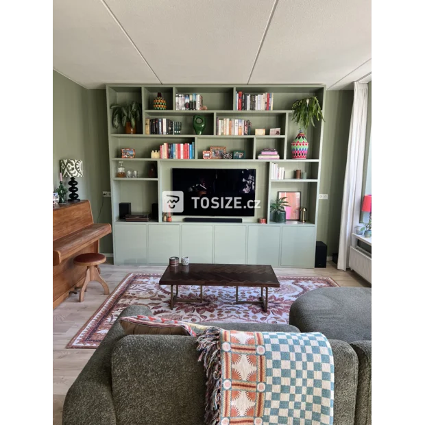 Green cupboard wall with open compartments and doors