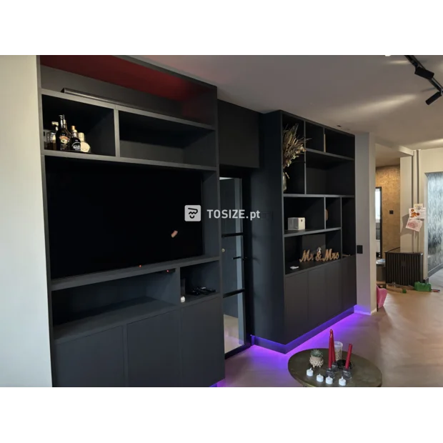 Black cupboard wall with open compartments and doors