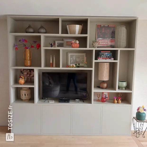 Gray cupboard wall with open compartments and doors