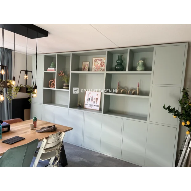 Green cupboard wall with doors and open compartments