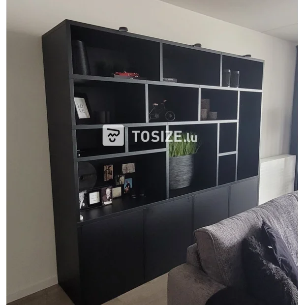 Black cupboard wall with open compartments and doors