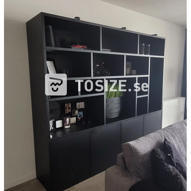 Black cupboard wall with open compartments and doors