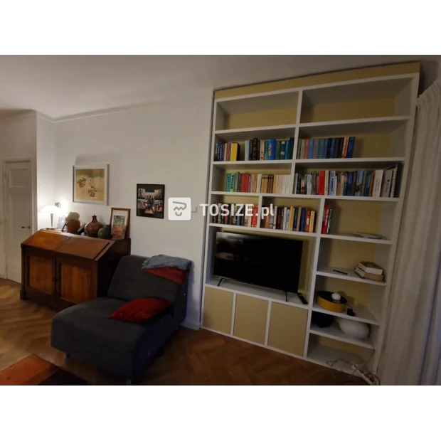 Yellow cupboard wall with open compartments and doors