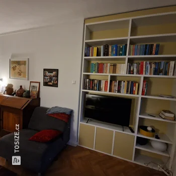 White and Yellow Bookcase with TV, by Ingrid