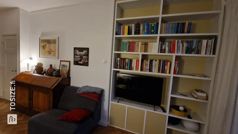 White and Yellow Bookcase with TV, by Ingrid