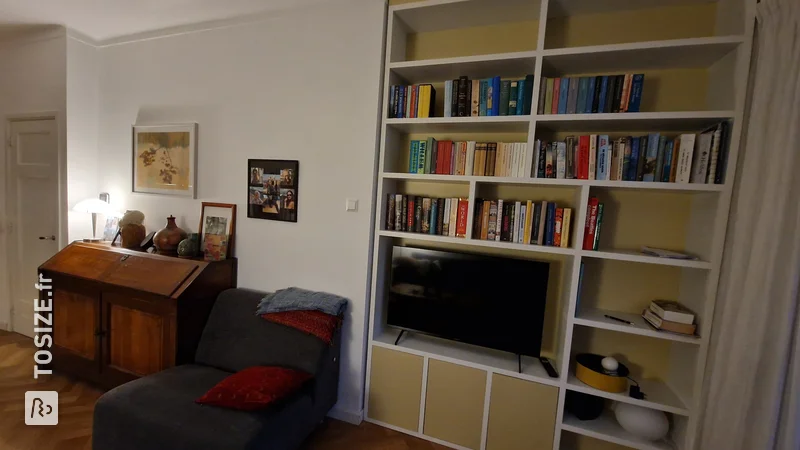 White and Yellow Bookcase with TV, by Ingrid