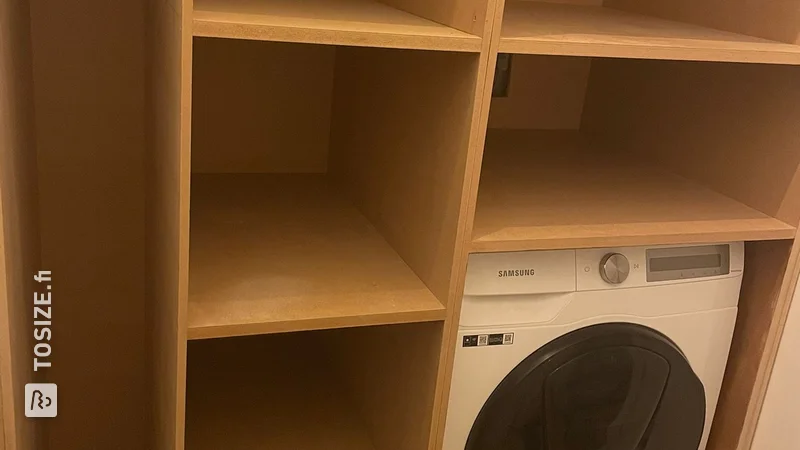 Custom built-in laundry room cupboard by Joy