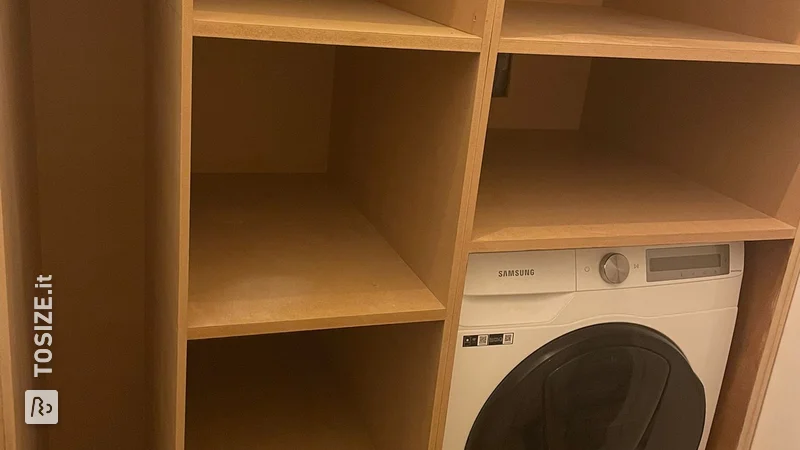 Custom built-in laundry room cupboard by Joy