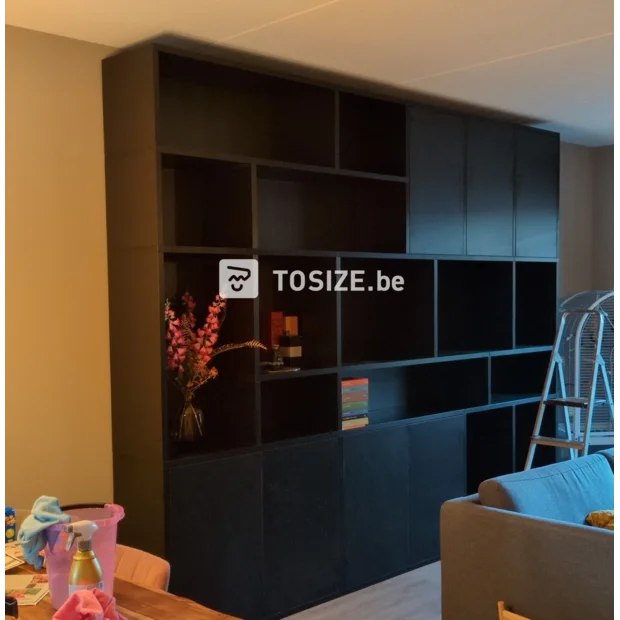 Black cupboard wall with open compartments and doors