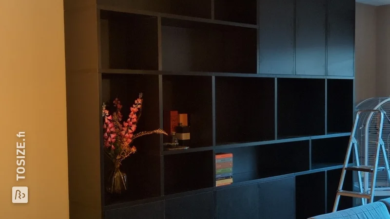 Stylish black bookcase in the living room, by Pieter