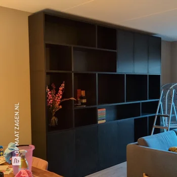 Stylish black bookcase in the living room, by Pieter