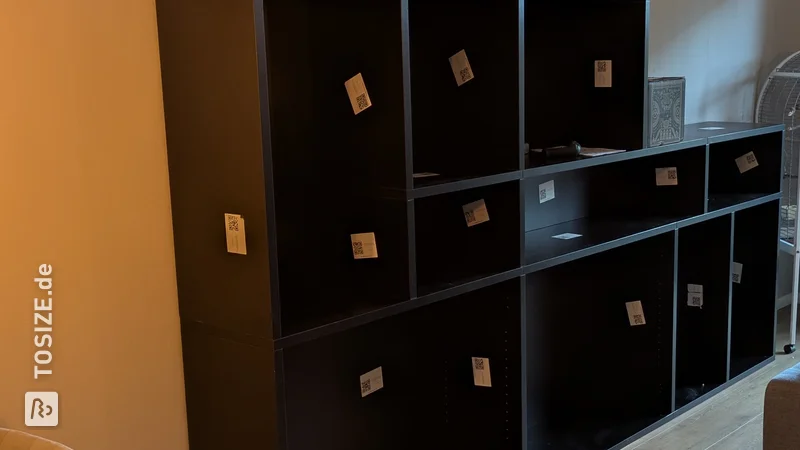 Stylish black bookcase in the living room, by Pieter