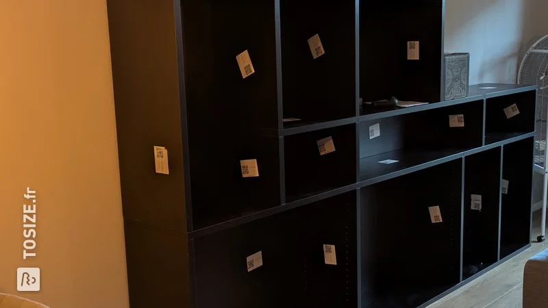 Stylish black bookcase in the living room, by Pieter