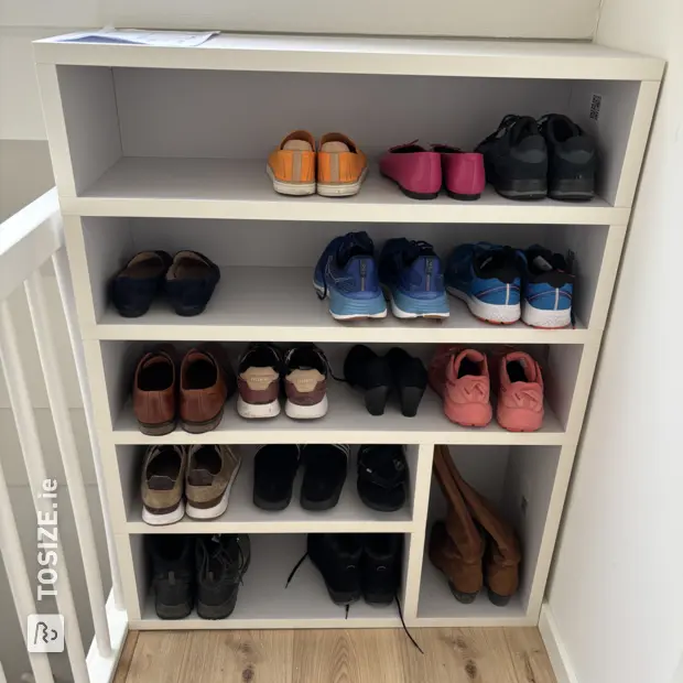 White shoe cabinet with open compartments and shelves