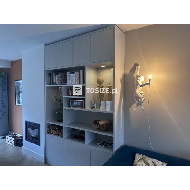 Light gray cupboard wall with doors and open compartments