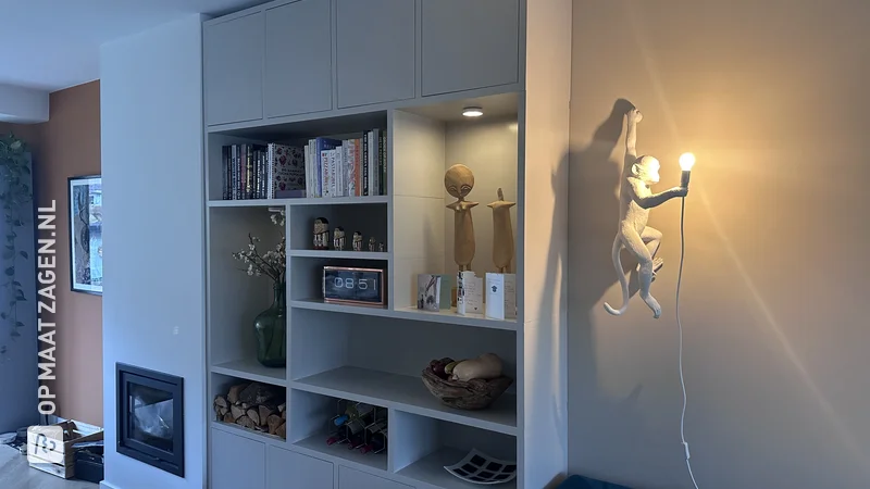 Beige shelving unit with spotlights and doors, by Alex