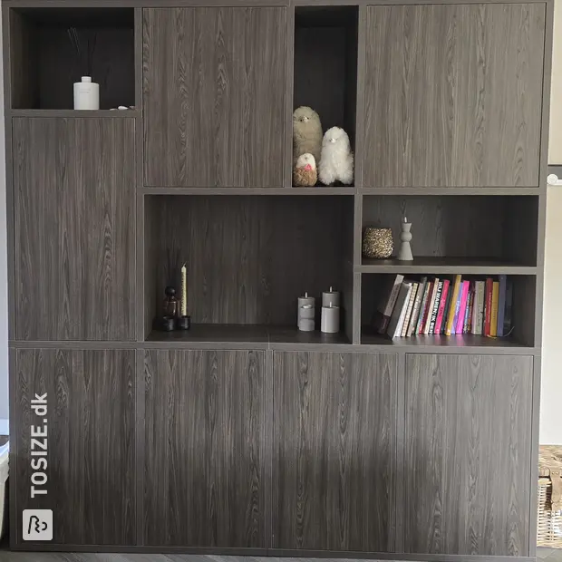 Dark cupboard wall with doors and open compartments