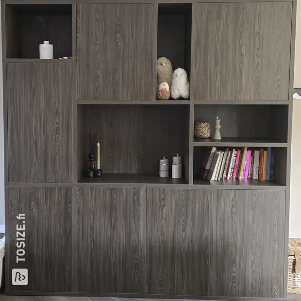 Dark cupboard wall with doors and open compartments