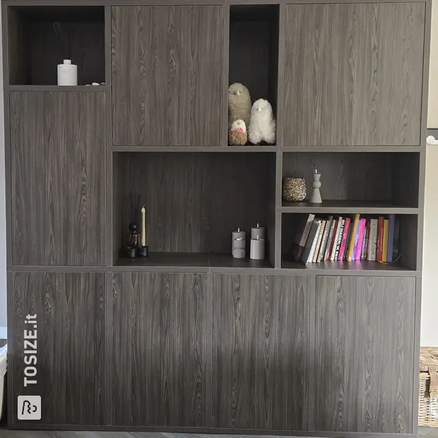 Dark cupboard wall with doors and open compartments
