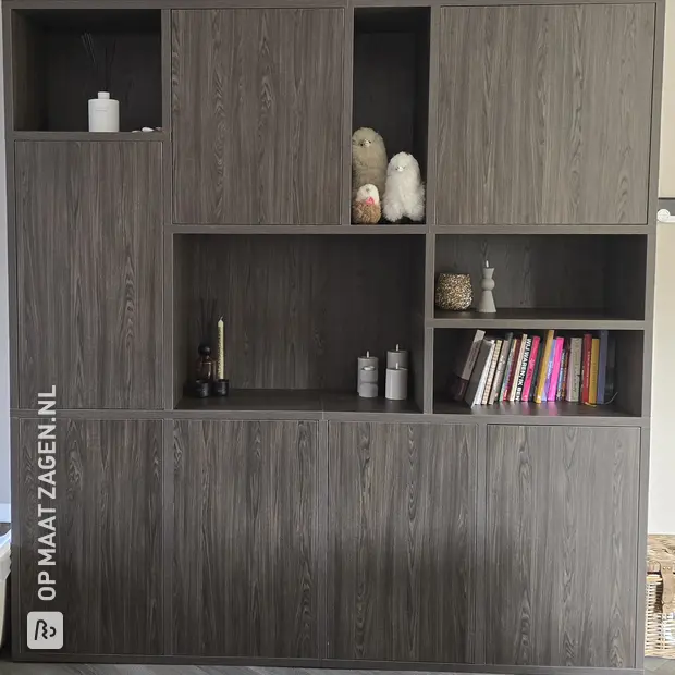 Dark cupboard wall with doors and open compartments