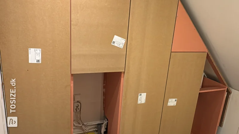 Practical attic cupboard under the knee wall for the central heating boiler, by Hein