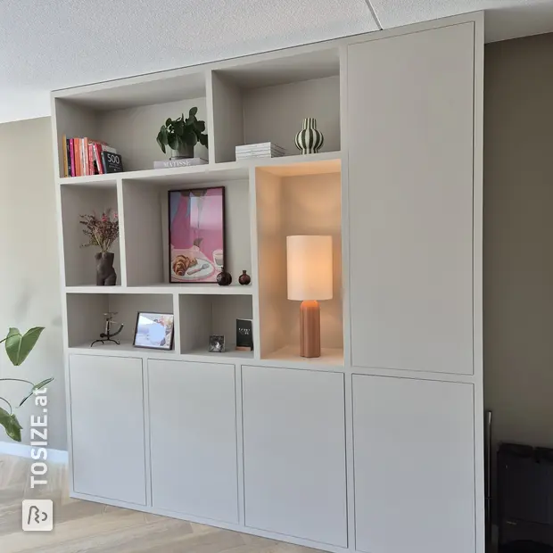 Cream cupboard wall with doors and open compartments