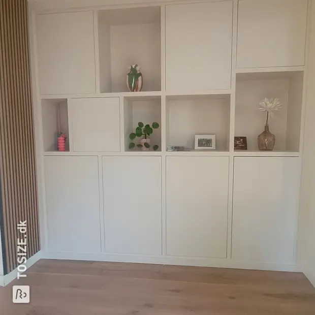 White cupboard wall with doors and open compartments