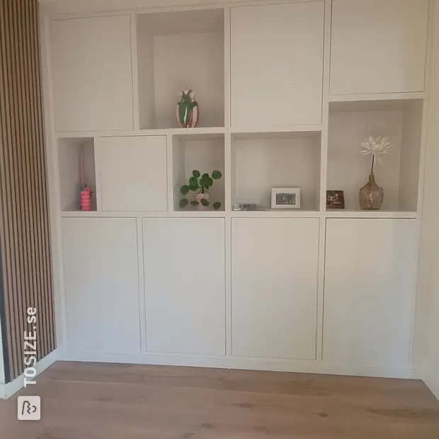 White cupboard wall with doors and open compartments