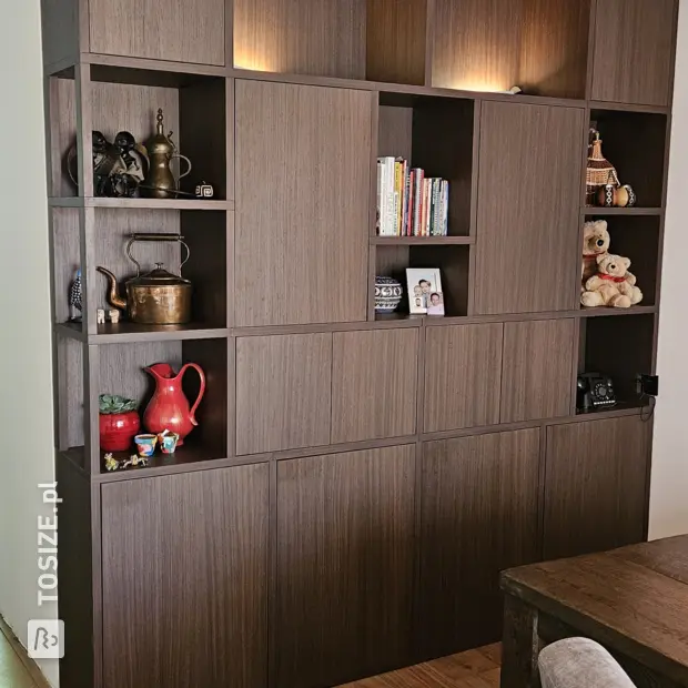 Dark cupboard wall with open compartments and doors