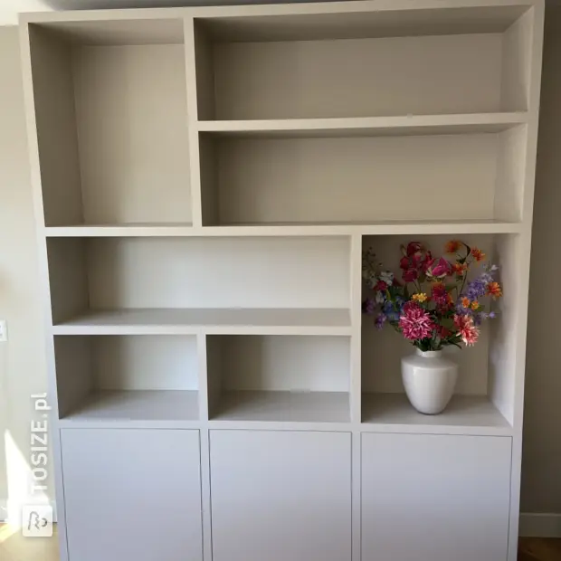 Cream cupboard wall with open compartments and doors