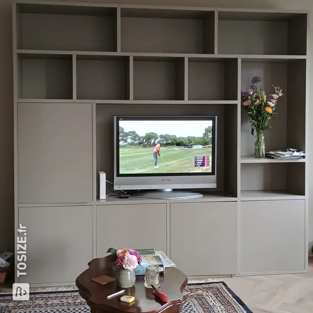 Beige cupboard wall with open compartments and doors