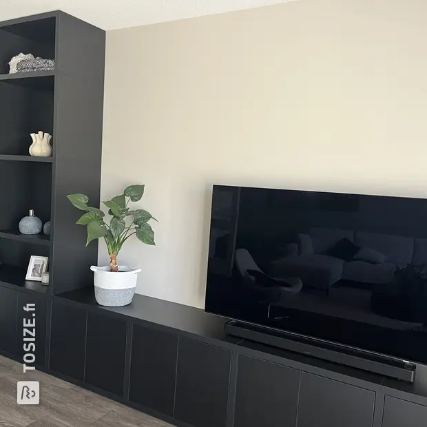 Black cupboard wall with open compartments and doors