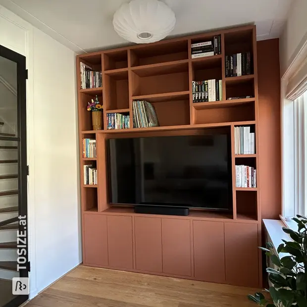 Red cupboard wall with open compartments and doors