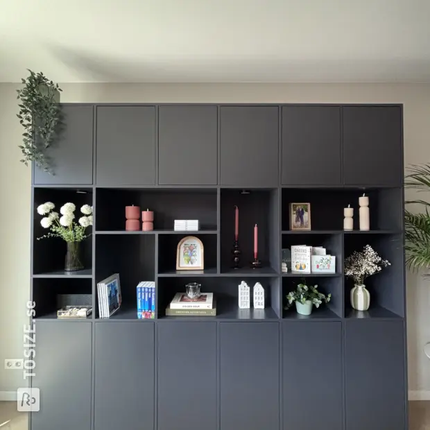 Black cupboard wall with open compartments and doors