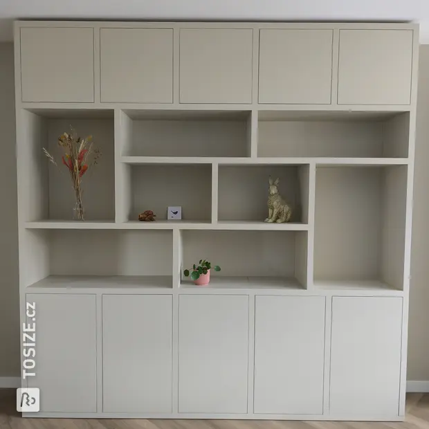 Cream cupboard wall with open compartments and doors