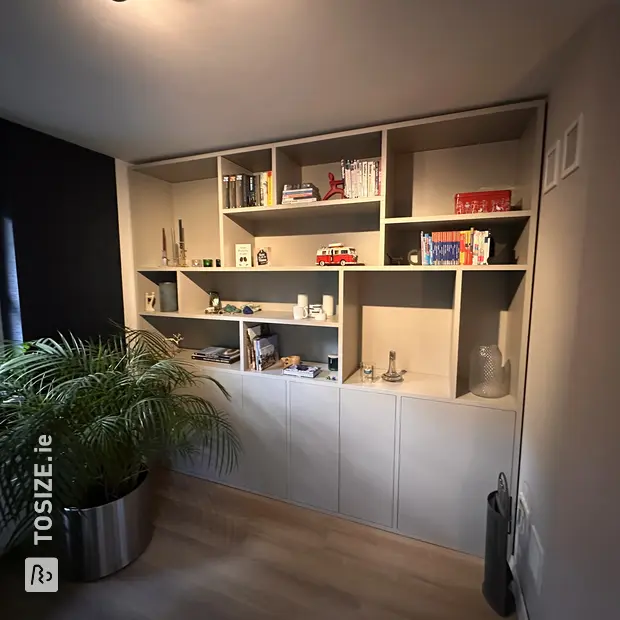 Gray cupboard wall with open compartments and doors