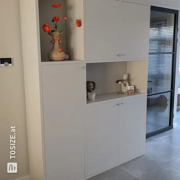 Cream cabinet with open compartments and doors
