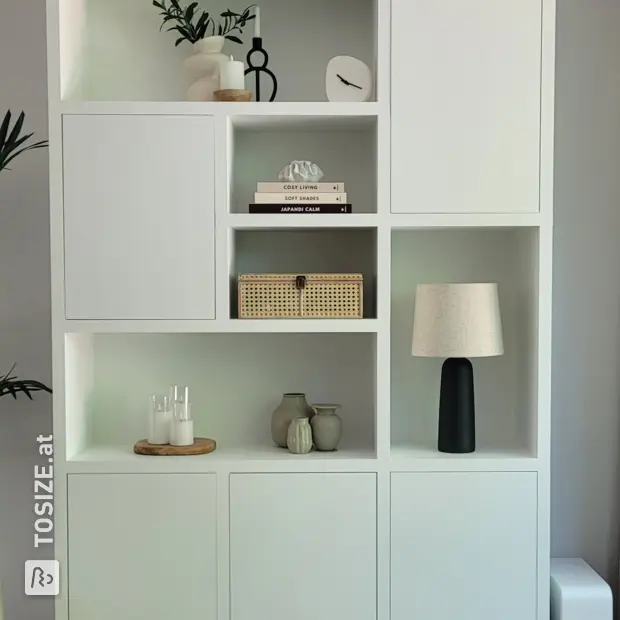 White cupboard wall with doors and open compartments