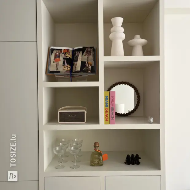Cream cupboard wall with open compartments and doors