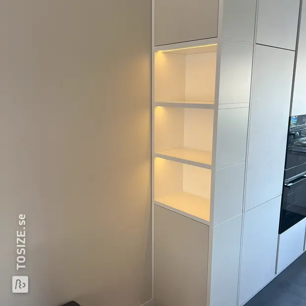 White cupboard wall with doors and open compartments
