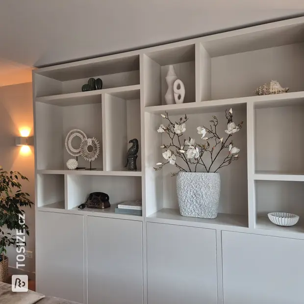 Gray cupboard wall with open compartments and doors