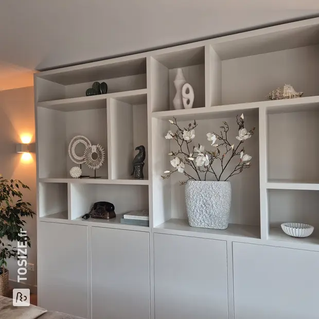 Gray cupboard wall with open compartments and doors
