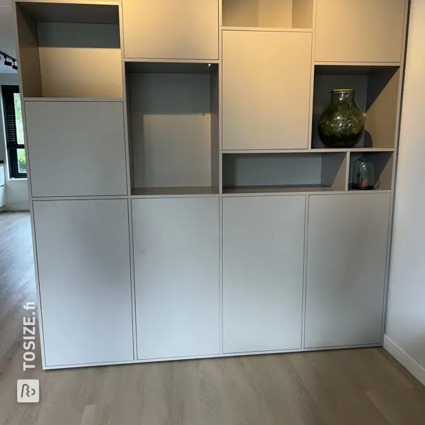 Gray shelving unit with open compartments and doors