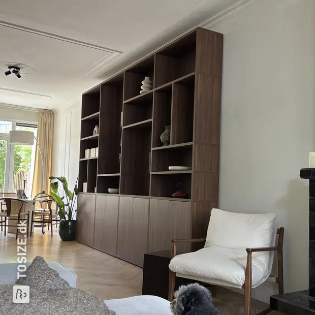 Dark wooden cupboard wall with open compartments and doors