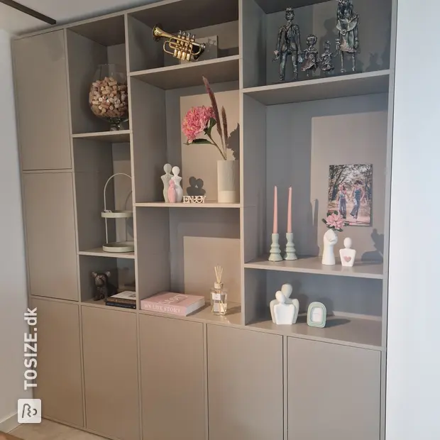 Gray cupboard wall with open compartments and doors