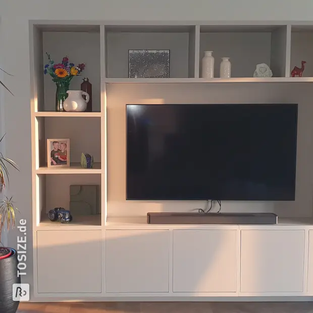 Cream cabinet wall with open compartments and doors