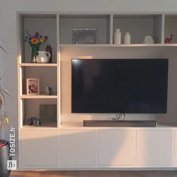 Cream cabinet wall with open compartments and doors
