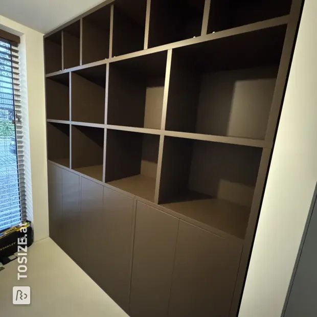 Brown cupboard wall with open compartments and doors